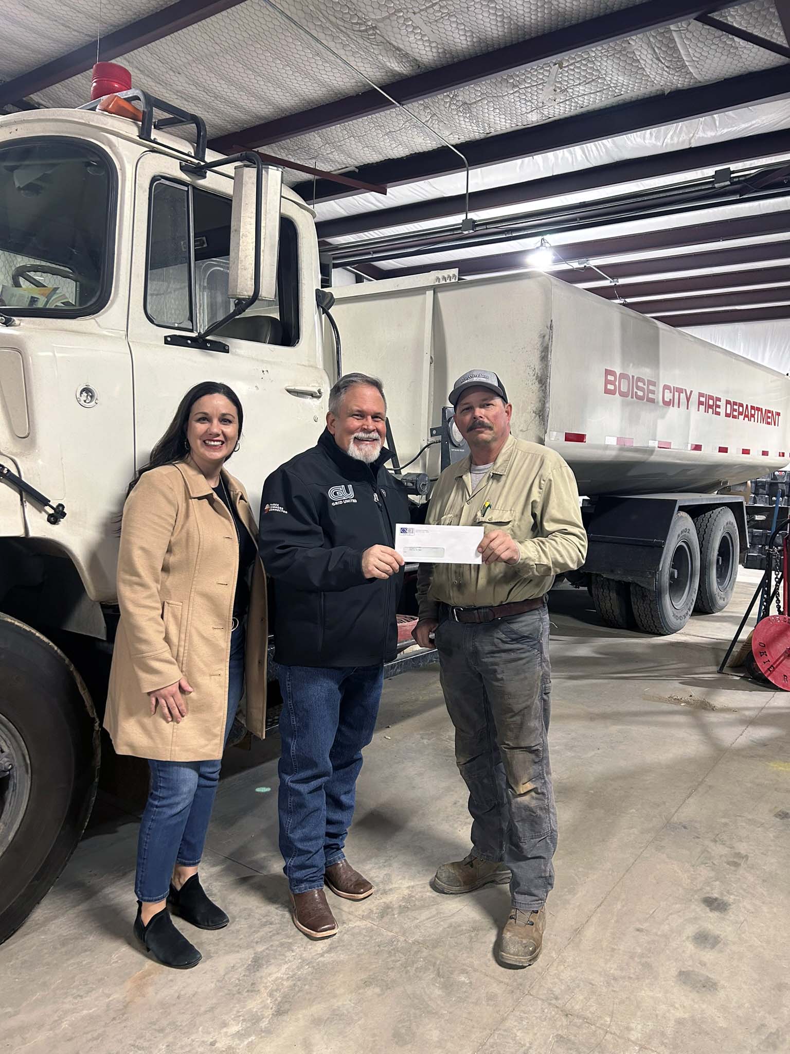 Boise City Fire Department – Pictured left to right – Carrie Sanders, CSCF Executive Director; Alan Manning, Three Corners Connector Project Communications Specialist; presents check to David Odell, Boise City Fire Chief