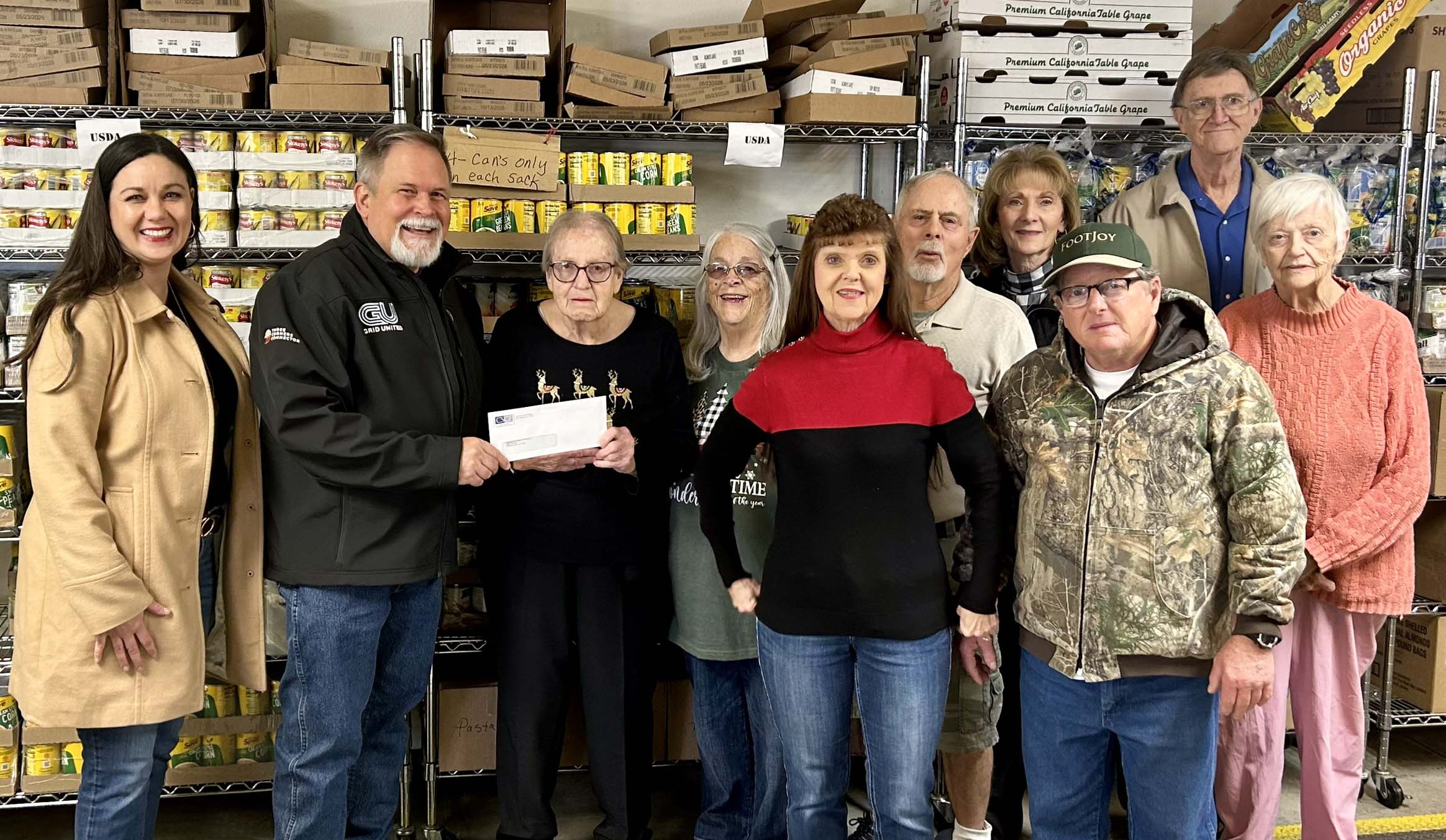 Loaves & Fishes Food Cupboard - pictured left to right - Carrie Sanders, CSCF Executive Director; Alan Manning, Three Corners Connector Project Communications Specialist; presenting the check to Gail Parsley, Loaves & Fishes Manager and volunteers